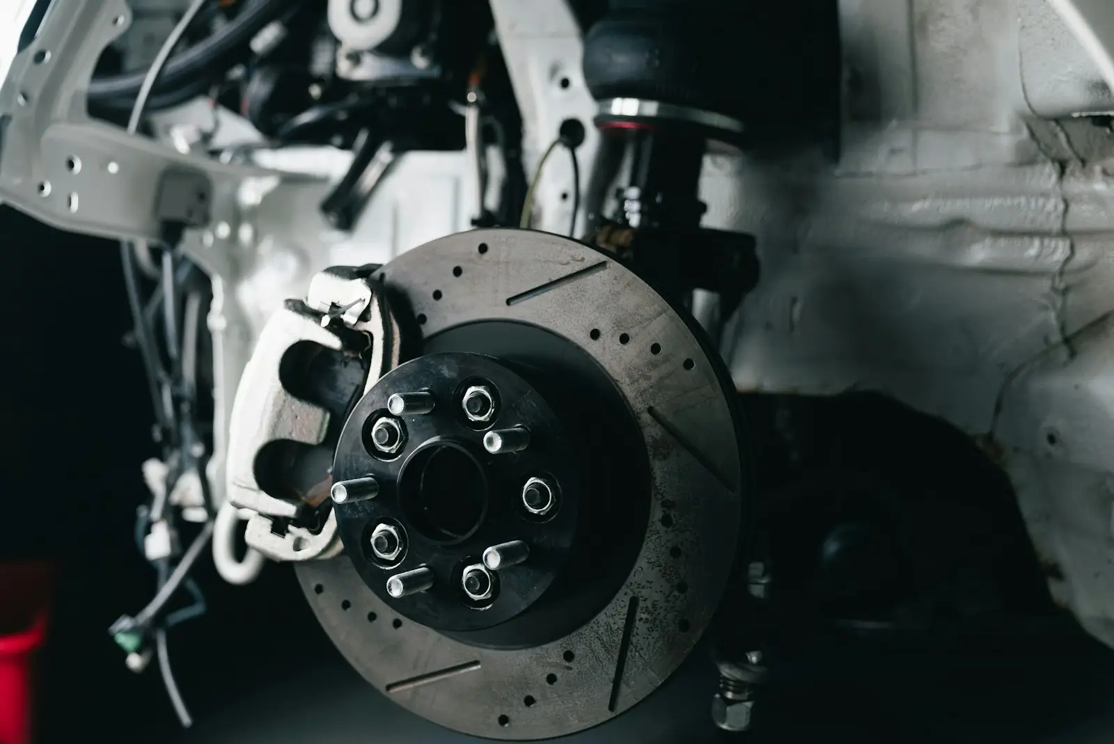 Drilled brake rotor and caliper with the wheel removed